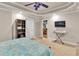 Comfortable bedroom with carpet flooring, tray ceiling, ceiling fan, and neutral paint at 1811 Mcconnell Rd, Grayson, GA 30017