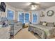 Bright bedroom featuring a crib, a full sized bed, multiple windows, and ceiling fan at 1811 Mcconnell Rd, Grayson, GA 30017