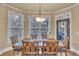 Bright dining room with a wooden table set, natural light, and views of the outdoors at 1811 Mcconnell Rd, Grayson, GA 30017