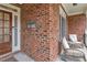 Welcoming front porch with seating area, brick accents, and classic columns at 1811 Mcconnell Rd, Grayson, GA 30017