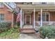 Inviting front porch with brick accents and classic white columns and railings at 1811 Mcconnell Rd, Grayson, GA 30017