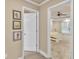 Hallway featuring vinyl flooring, framed art, and view to the main bedroom with trey ceilings at 1811 Mcconnell Rd, Grayson, GA 30017