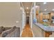Hallway leading to a kitchen with granite counters and stainless steel appliances at 1811 Mcconnell Rd, Grayson, GA 30017