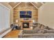 Comfortable living room featuring a wood accent wall, fireplace, and ample seating at 1811 Mcconnell Rd, Grayson, GA 30017