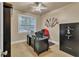 Functional home office with carpet floors, sleek black desk, and window for natural light at 1811 Mcconnell Rd, Grayson, GA 30017
