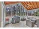 Relaxing screened porch with outdoor furniture, ceiling fan, and views of the wooded backyard at 1811 Mcconnell Rd, Grayson, GA 30017