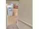 Beige stairway that opens up to the kitchen with wood look flooring and stainless steel appliances at 1811 Mcconnell Rd, Grayson, GA 30017