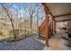 Lovely back porch with stone landscaping, ceiling fan and outdoor seating at 217 Colonial Dr, Woodstock, GA 30189