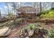 Landscaped backyard features a terraced garden and mature trees at 217 Colonial Dr, Woodstock, GA 30189