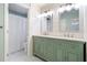 Stylish bathroom features a dual vanity, marble countertops, and decorative mirrors at 217 Colonial Dr, Woodstock, GA 30189