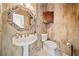 Chic powder room with pedestal sink, decorative mirror, and unique textured wallpaper at 217 Colonial Dr, Woodstock, GA 30189