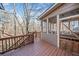 Deck featuring access to the house's sunroom, wooden railings and wooded views at 217 Colonial Dr, Woodstock, GA 30189