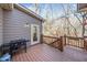 Outdoor deck with grill and a view of the private wooded backyard at 217 Colonial Dr, Woodstock, GA 30189