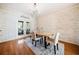 Charming dining room with wood-paneled walls, stylish lighting, and space for entertaining at 217 Colonial Dr, Woodstock, GA 30189