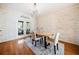 Charming dining room featuring wood paneling, stylish chandelier, and french doors to the backyard at 217 Colonial Dr, Woodstock, GA 30189