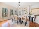 Bright dining room with large windows, hardwood floors, and stylish pendant lighting at 217 Colonial Dr, Woodstock, GA 30189