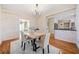 An inviting dining room with rustic wood walls, hardwood floors, and an open connection to the modern kitchen at 217 Colonial Dr, Woodstock, GA 30189