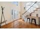 Bright entryway with hardwood floors, decorative glass front door, coat rack, and staircase at 217 Colonial Dr, Woodstock, GA 30189