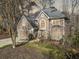 Beautiful two-story stucco home showcasing a landscaped yard with mature trees on a sunny day at 217 Colonial Dr, Woodstock, GA 30189