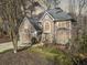 Lovely landscaped home featuring a two-car garage, manicured lawn, and an inviting front entrance in a wooded lot at 217 Colonial Dr, Woodstock, GA 30189