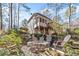Backyard firepit with Adirondack chairs and a view of the home at 217 Colonial Dr, Woodstock, GA 30189