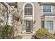 Close-up of front of home with covered entry and well-manicured front bushes at 217 Colonial Dr, Woodstock, GA 30189