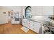 Bright, white kitchen featuring stainless steel appliances, subway tile backsplash, and a large farmhouse sink at 217 Colonial Dr, Woodstock, GA 30189