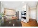 A gourmet kitchen boasts stainless appliances, custom cabinets, granite counters and opens to the dining area at 217 Colonial Dr, Woodstock, GA 30189