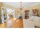 Open-concept living room with hardwood floors, and large windows, connecting seamlessly to adjacent rooms at 217 Colonial Dr, Woodstock, GA 30189