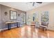 Sitting room with hardwood floors, three windows, and two chairs at 217 Colonial Dr, Woodstock, GA 30189