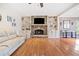 Living room with fireplace, built-in bookshelves, hardwood floors, and ample natural light at 217 Colonial Dr, Woodstock, GA 30189