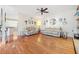 Inviting living room with hardwood floors, ceiling fan, and views into kitchen at 217 Colonial Dr, Woodstock, GA 30189
