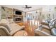 Expansive living room with a stone fireplace, built-in shelving, and open access to the dining area at 217 Colonial Dr, Woodstock, GA 30189
