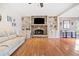 Spacious living room featuring a stone fireplace, built-in shelving, and hardwood flooring at 217 Colonial Dr, Woodstock, GA 30189