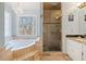 Gorgeous main bathroom with garden tub, chandelier, and walk-in shower at 217 Colonial Dr, Woodstock, GA 30189