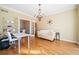 Bright office with hardwood floors, French doors, chandelier, built-in bookcase and a comfortable seating area at 217 Colonial Dr, Woodstock, GA 30189