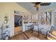 Relaxing screened-in patio with ceiling fan, cushioned chairs, and rustic decor at 217 Colonial Dr, Woodstock, GA 30189