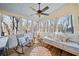 Cozy screened-in porch with plenty of seating and views of the wooded landscape at 217 Colonial Dr, Woodstock, GA 30189