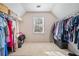 Bright walk-in closet with ample storage and a center window at 217 Colonial Dr, Woodstock, GA 30189