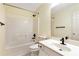Bright bathroom features a tub-shower combination, toilet, and sink with a vanity at 386 Creek Manor Way, Suwanee, GA 30024
