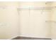 Walk-in closet provides ample storage with built-in metal shelving, offering organization and functionality at 386 Creek Manor Way, Suwanee, GA 30024