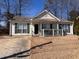 Charming single-story home with neutral siding, large windows, and a cozy front porch at 6163 Princeton Ave, Morrow, GA 30260