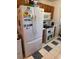 Efficient kitchen featuring modern white appliances, ample cabinet space, and stylish black and white floors at 6163 Princeton Ave, Morrow, GA 30260
