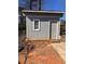 View of a simple shed with a door and window in the back yard at 6163 Princeton Ave, Morrow, GA 30260