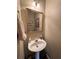 Cozy half-bathroom with pedestal sink and neutral decor at 6302 Manassas Nw Pass, Acworth, GA 30101