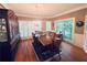 A spacious dining room with hardwood floors, natural light, and a beautiful chandelier and wooden table at 6302 Manassas Nw Pass, Acworth, GA 30101