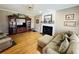 Comfortable living room with a fireplace, hardwood floors, and a cozy sectional sofa at 6302 Manassas Nw Pass, Acworth, GA 30101