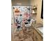 A full bathroom with tiled floor, granite vanity and colorful, nautical-themed shower curtain at 184 Cedarcrest Dr, Acworth, GA 30101