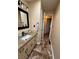 Updated bathroom with granite counters, modern fixtures, and a view of the hallway at 184 Cedarcrest Dr, Acworth, GA 30101