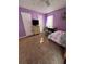 A bedroom featuring purple walls, desk, and carpeting, with a bed in the foreground at 184 Cedarcrest Dr, Acworth, GA 30101